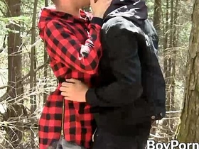 Two twinks indulge in oral pleasure with a well-endowed gay partner outdoors