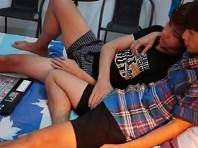 Gay twinks engage in foreplay and kissing after viewing erotic content